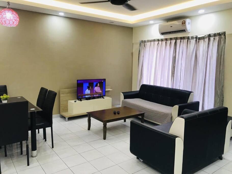 a living room with a couch and a tv at Home in Bayan Lepas4R3B Dnaz Homestay@Bayan Baru in Bayan Lepas