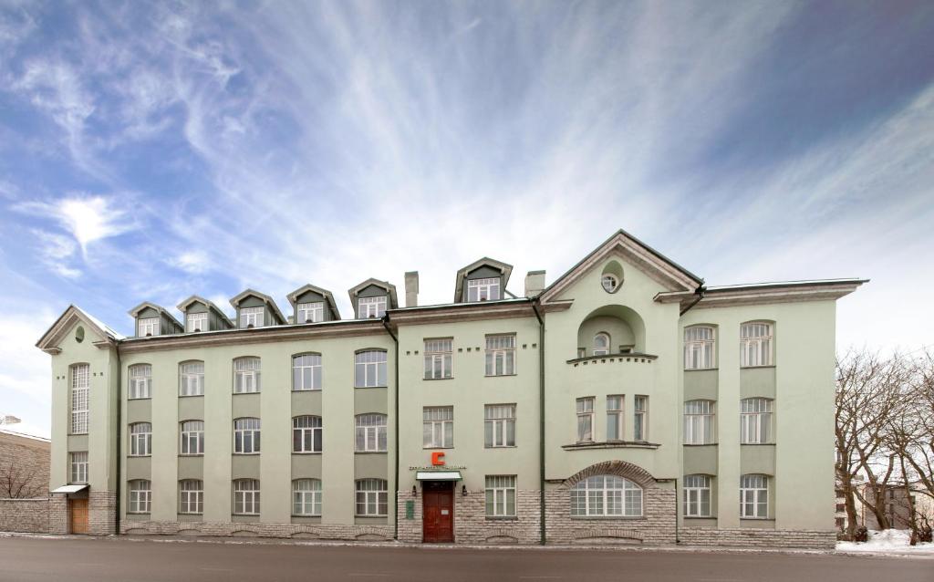 a large white building with a pointed roof at City Hotel Tallinn by Unique Hotels in Tallinn