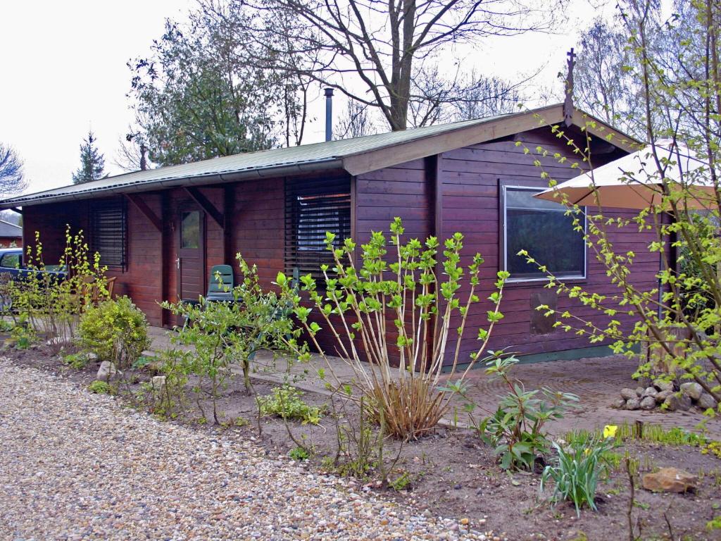 a house with a garden in front of it at Tidy chalet with a microwave in the Achterhoek in Ootmarsum