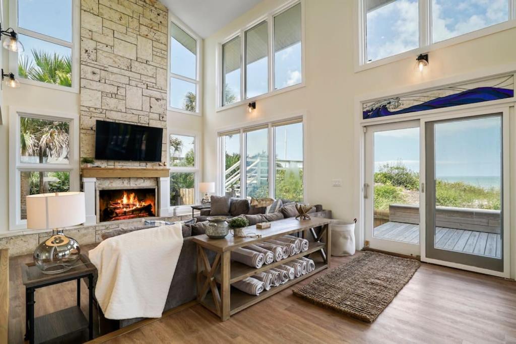 a living room with a couch and a fireplace at Crescent Lookout Oceanfront with panoramic views in St. Augustine