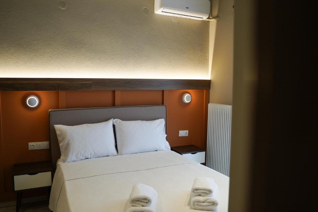 卡蘭巴卡的住宿－Grand View Suites Meteora，一间卧室配有带拖鞋的床铺