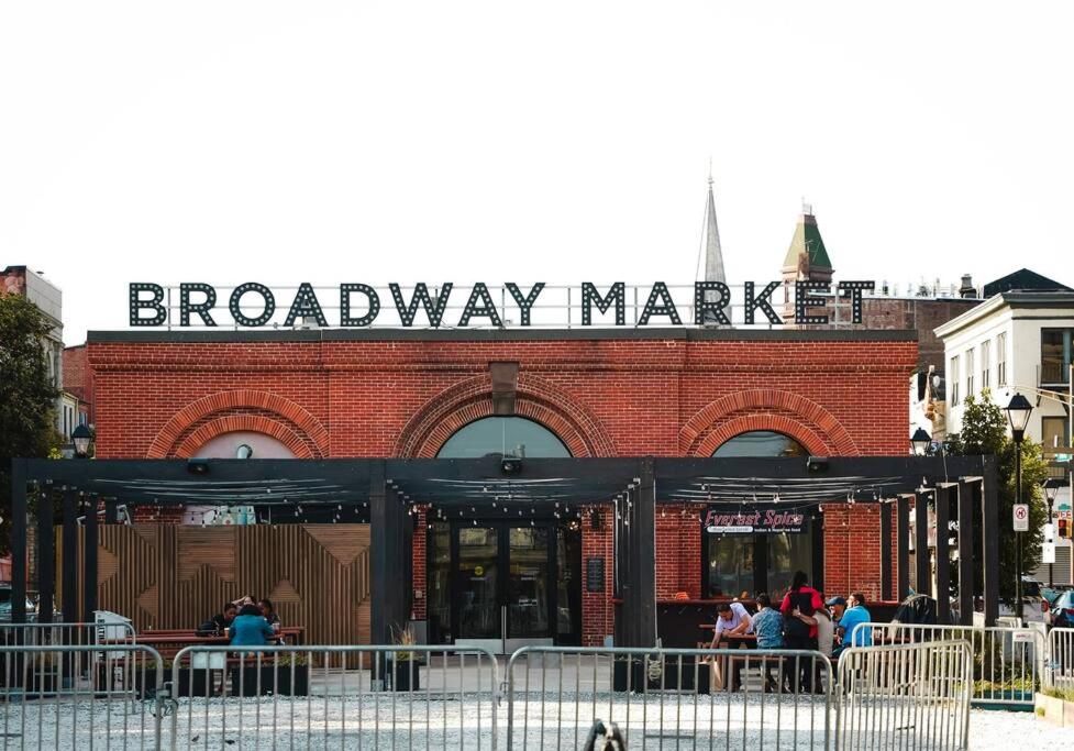 a brick building with a broadway market sign on it at Fells Point Charm Doubled! in Baltimore