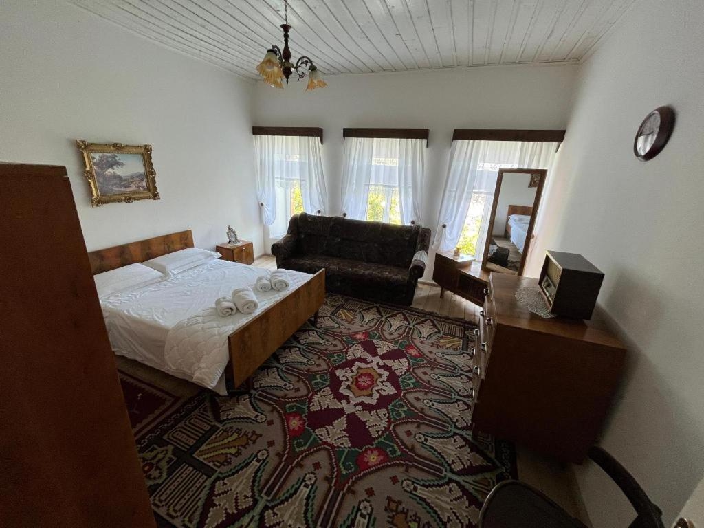 - une chambre avec un lit et une chaise dans l'établissement Traditional House Shapllo, à Gjirokastër