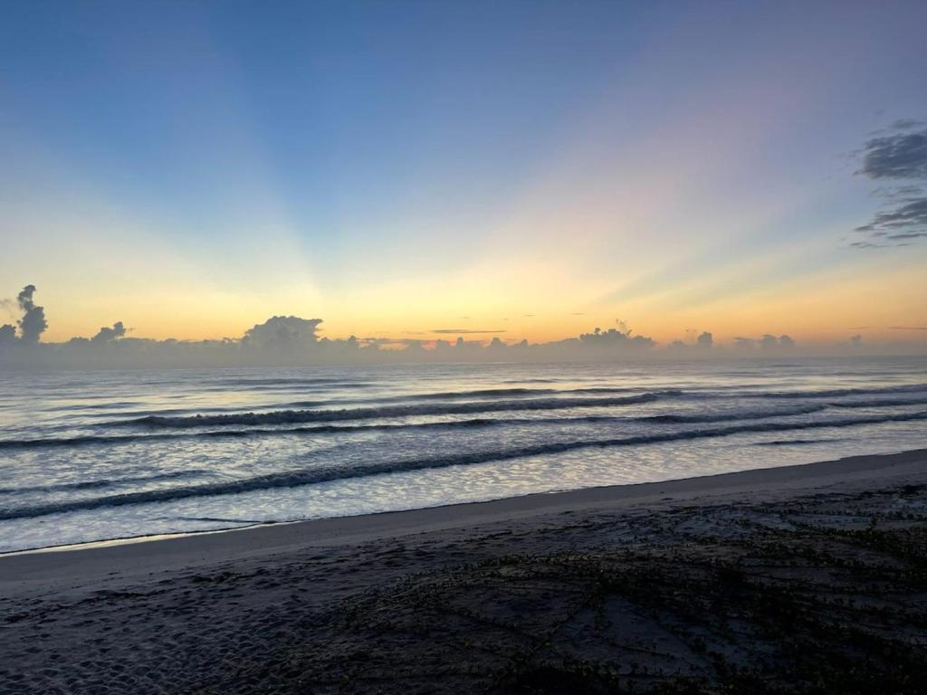 a view of the beach at sunset with the ocean at Serenity One 100 percent Oceanfront 6 Bedrooms in Ponte Vedra Beach