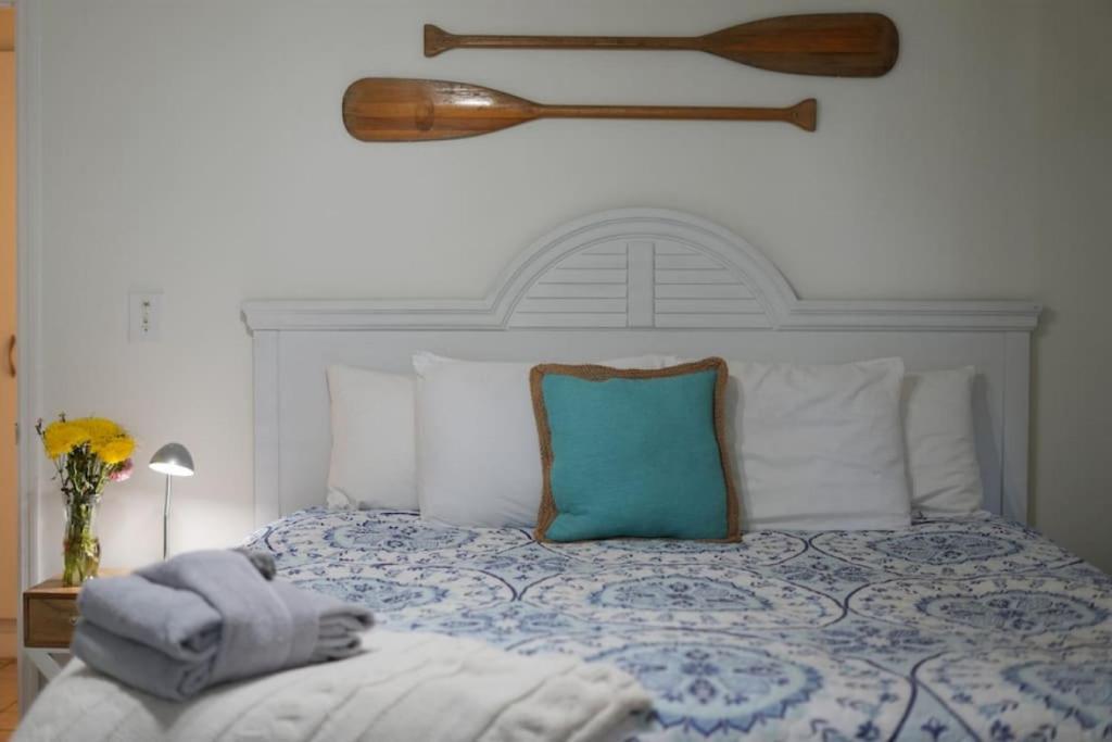 a bedroom with a bed with a blue and white comforter at Casa Blanca Casita by the Ocean in St. Augustine