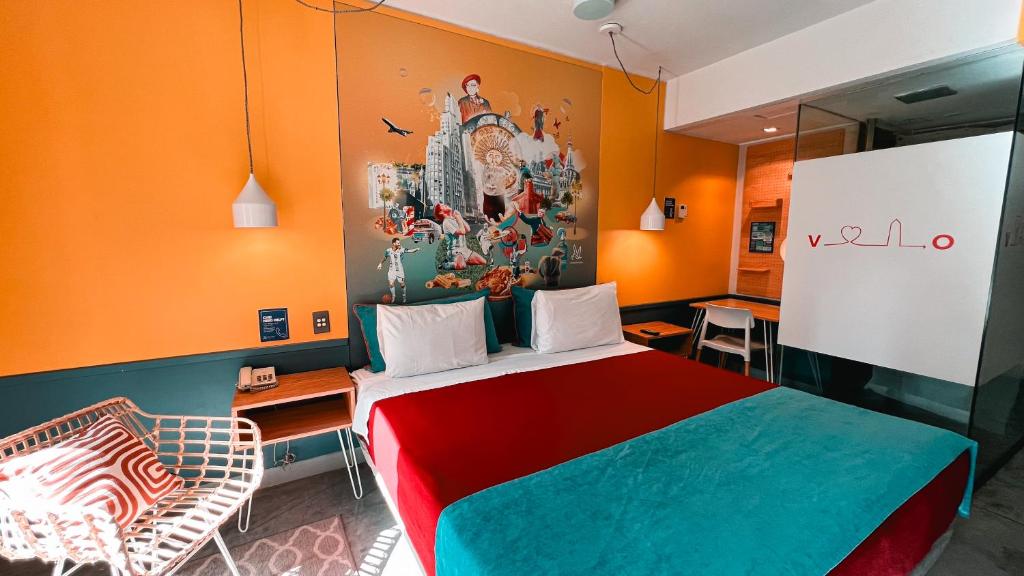 a room with a bed and a chair in it at Viajero Buenos Aires Hostel in Buenos Aires