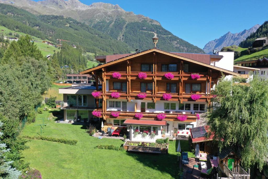 a large building with flowers on the side of it at Sportalm in Sölden