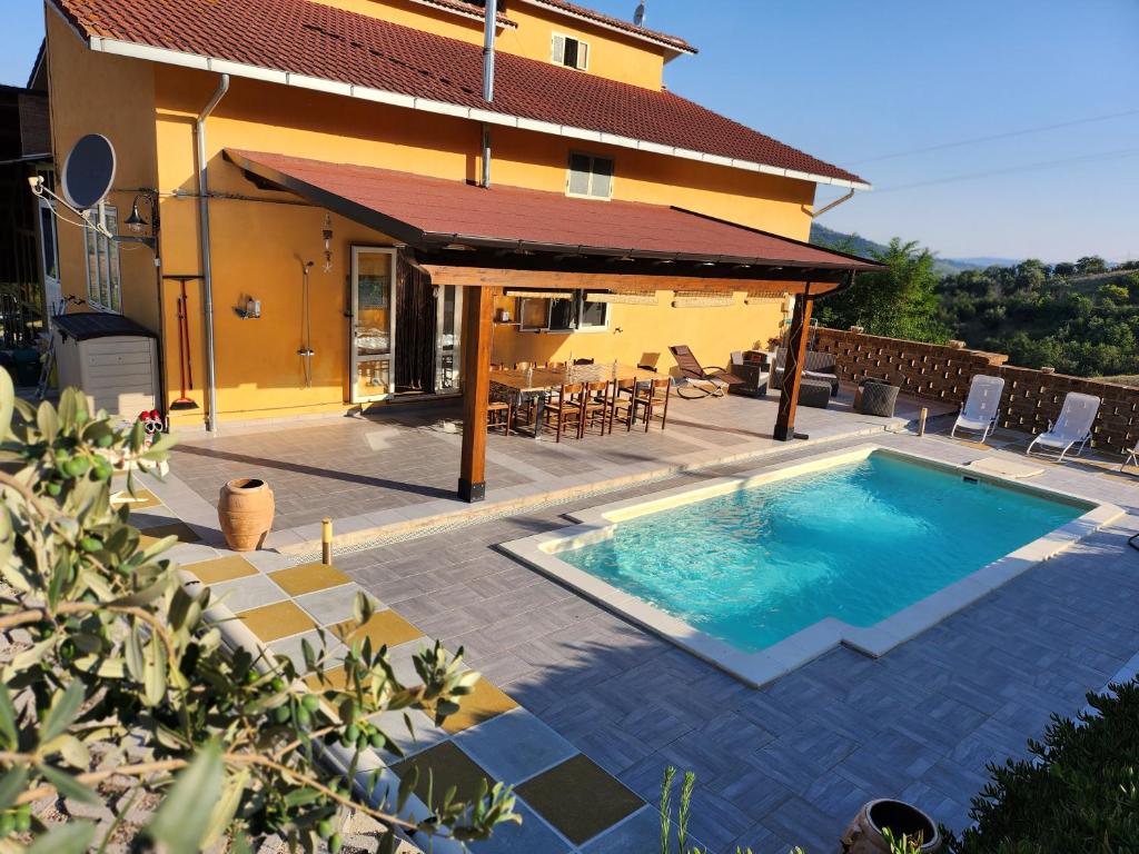 a swimming pool in front of a house at Casa dei Nonni in Roccascalegna