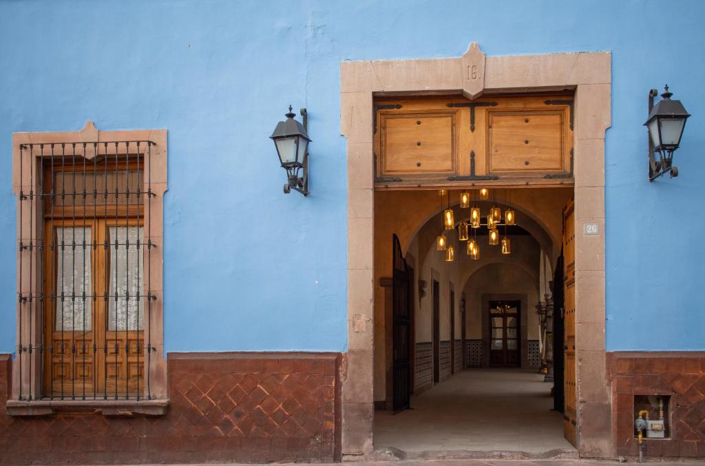 a blue building with two doors and two lights at Casa Montespejo B&B in Querétaro