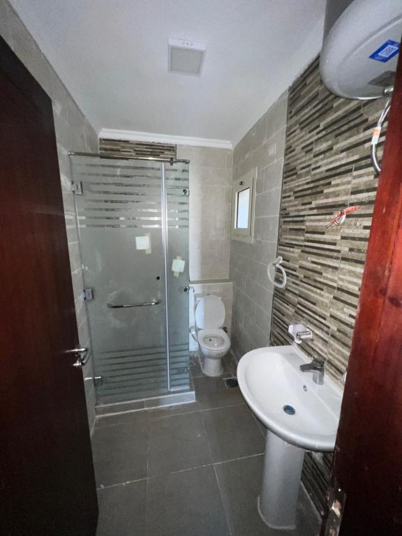 a bathroom with a shower and a sink and a toilet at Alamein apartments prime residence in El Alamein