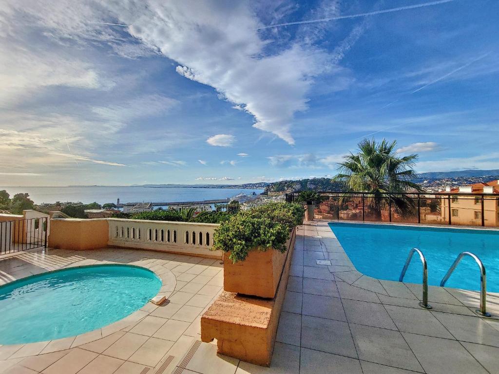 a swimming pool on the roof of a house at Nestor&amp;Jeeves - HUBLOT TERRASSE - Sea view - swimming pool in Nice