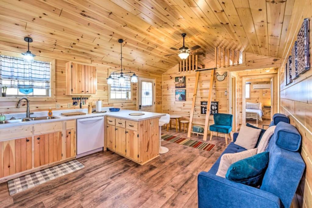 a kitchen and living room in a log cabin at Mammoth Cave Cabin Rentals 4 in Cub Run