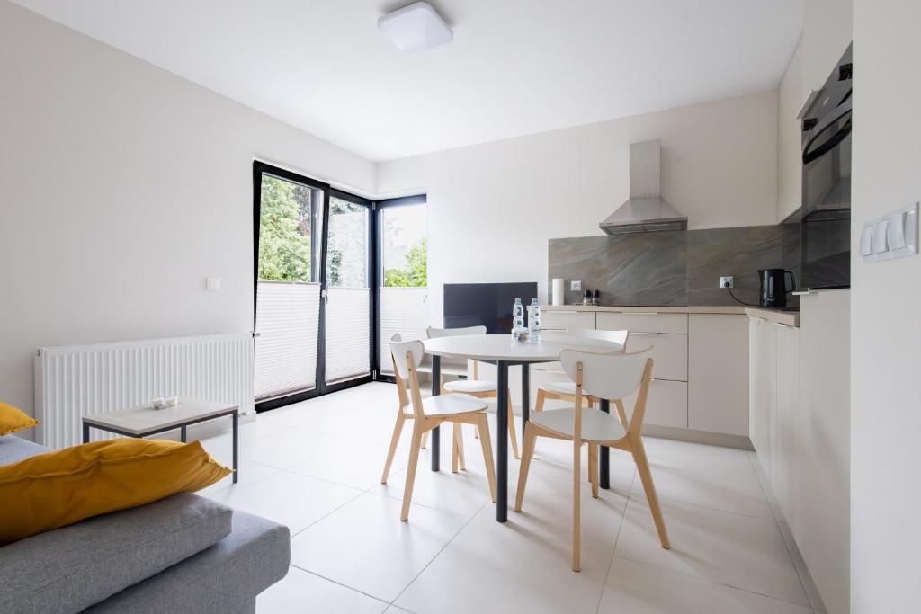 a kitchen and dining room with a table and chairs at Brzeska 22 in Łódź