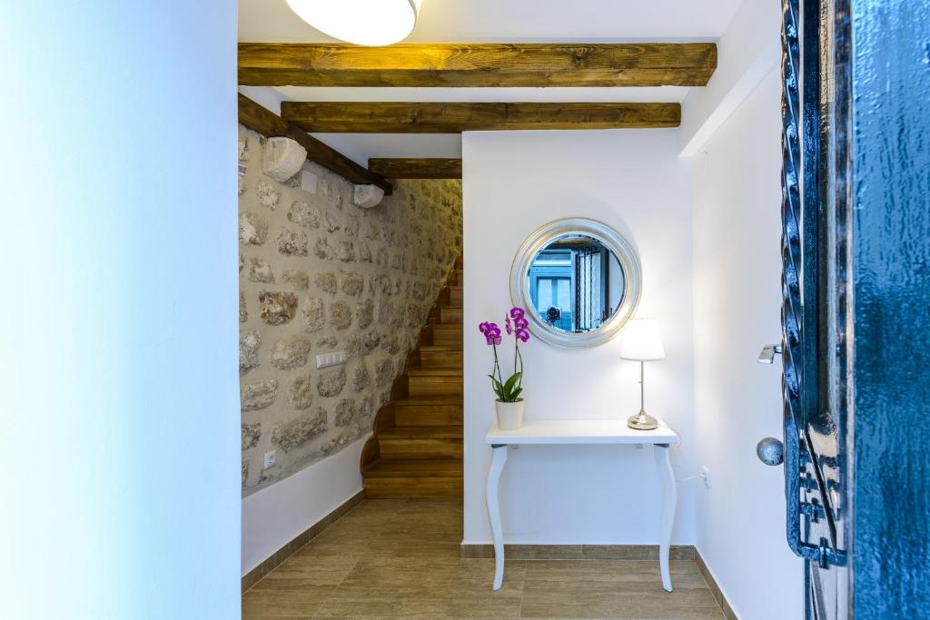 a hallway with a table and a mirror at Alberto Apartment in Dubrovnik