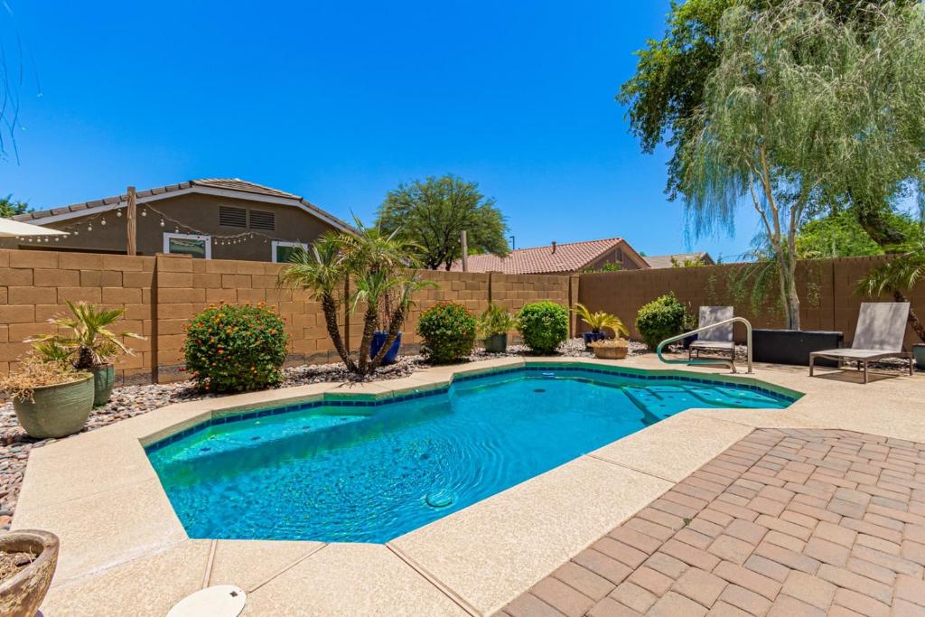 a swimming pool in a yard with a fence at Serenity Haven with Private Pool in Gilbert in Queen Creek