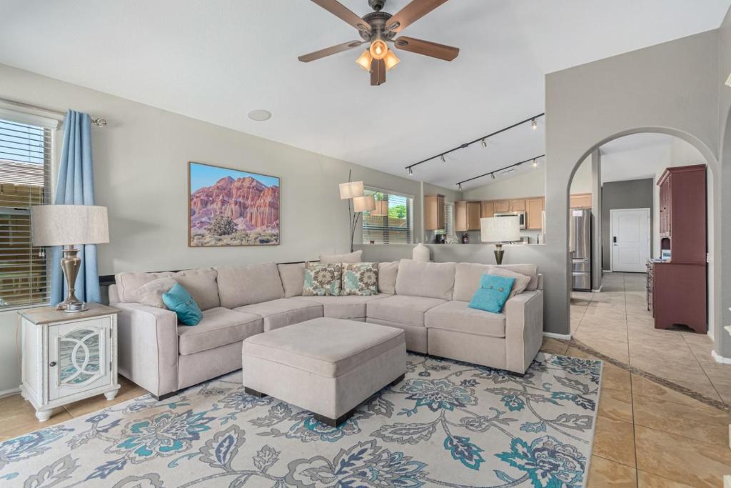 a living room with a couch and a ceiling fan at Serenity Haven with Private Pool in Gilbert in Queen Creek