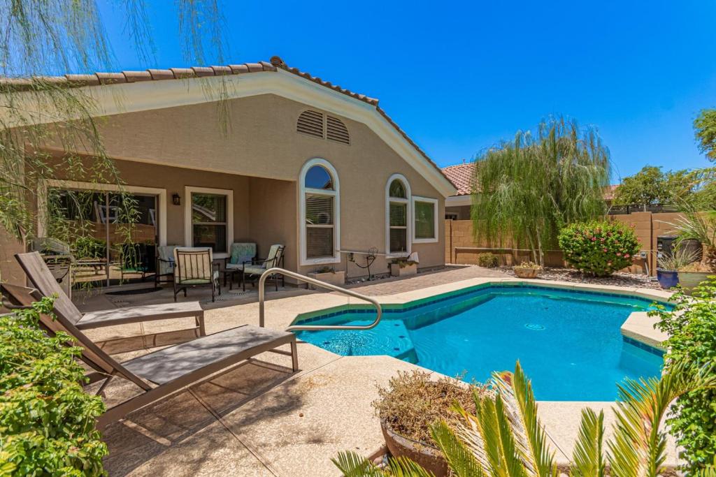 a swimming pool in front of a house at Serenity Haven with Private Pool in Gilbert in Queen Creek