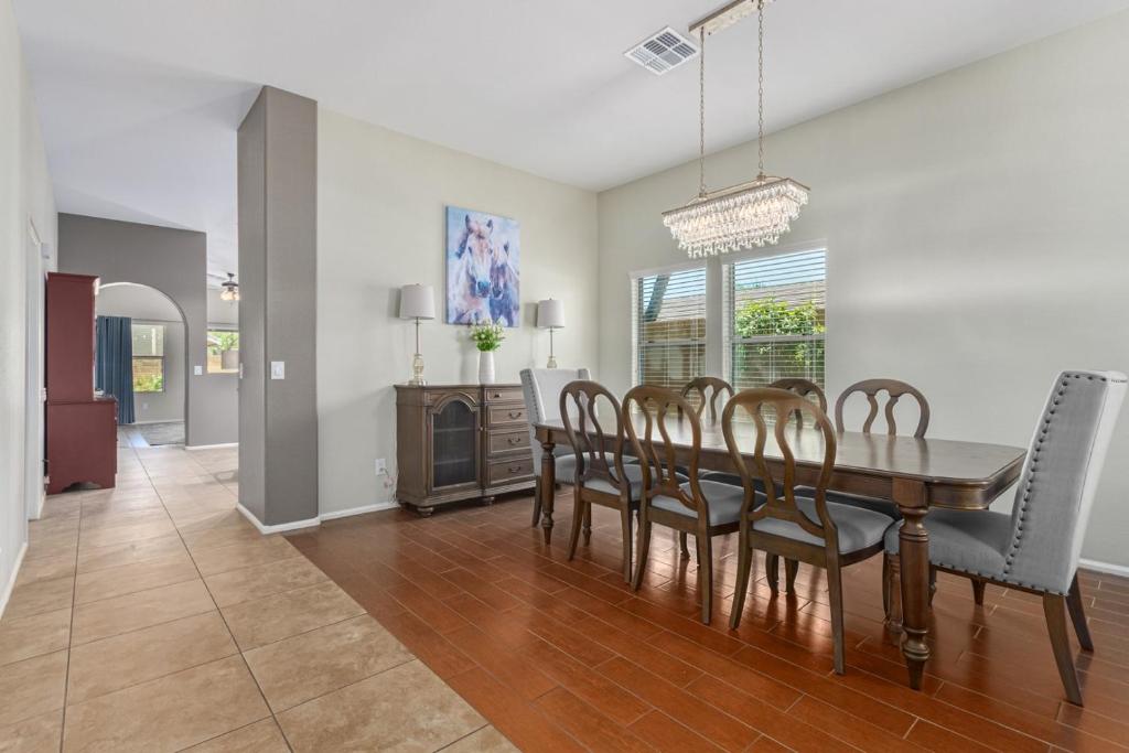 a dining room and living room with a table and chairs at Serenity Haven with Private Pool in Gilbert in Queen Creek