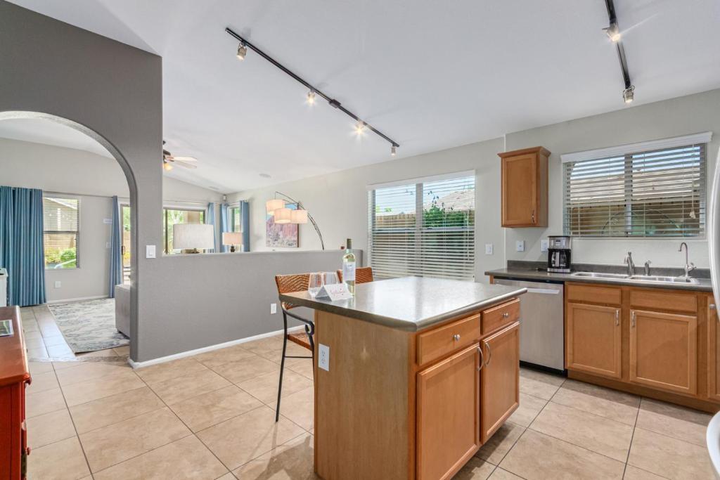 a kitchen with a island in the middle of it at Serenity Haven with Private Pool in Gilbert in Queen Creek
