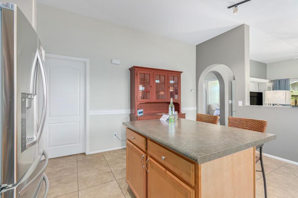 a kitchen with a counter and a refrigerator at Serenity Haven with Private Pool in Gilbert in Queen Creek