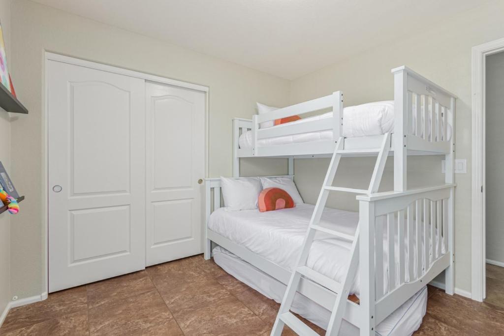 a white bunk bed in a white room with a ladder at Serenity Haven with Private Pool in Gilbert in Queen Creek