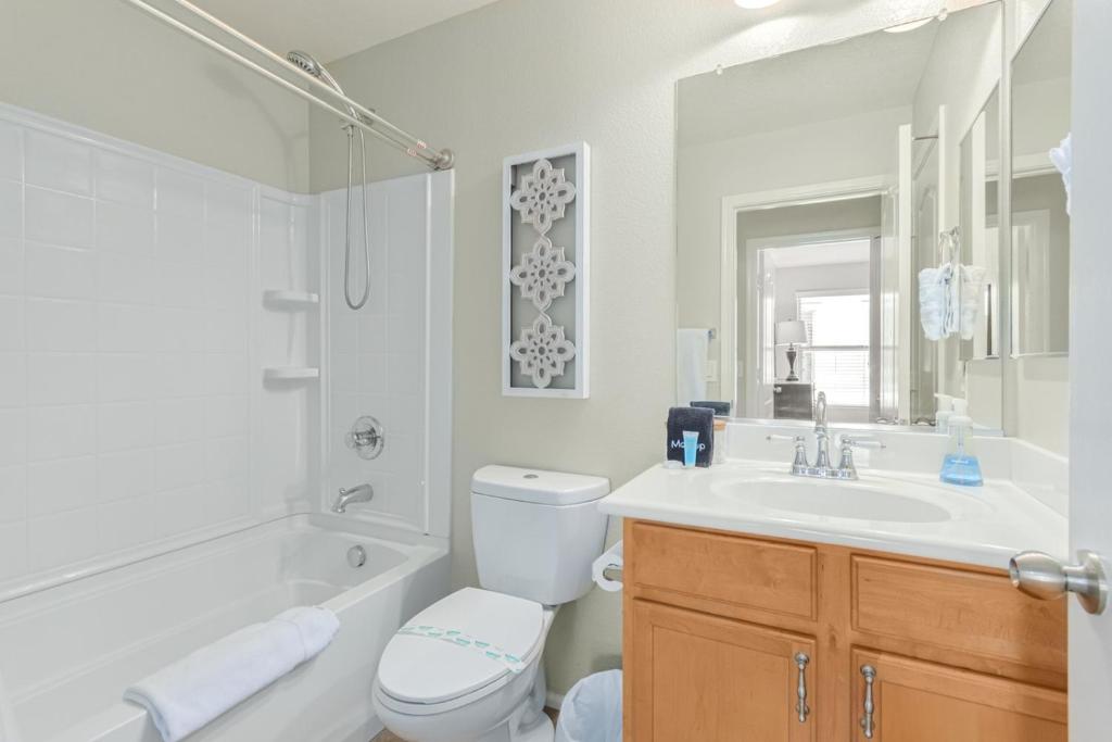 a white bathroom with a sink and a toilet and a tub at Serenity Haven with Private Pool in Gilbert in Queen Creek