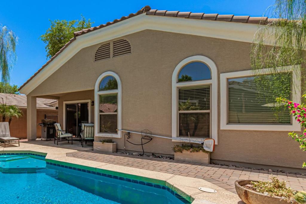 a house with a swimming pool in front of it at Serenity Haven with Private Pool in Gilbert in Queen Creek
