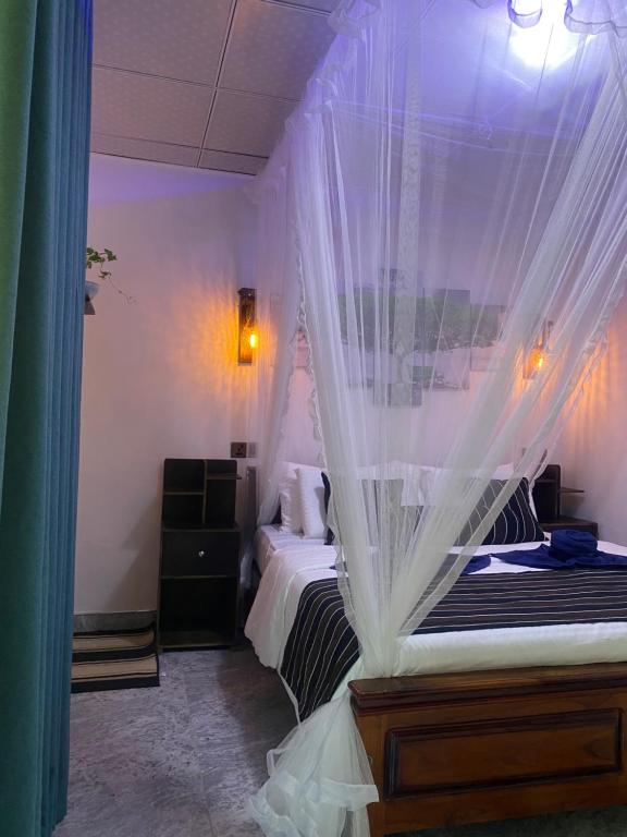 a bedroom with two beds with mosquito netting at Treetops ella in Ella