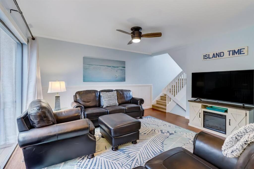 a living room with leather furniture and a flat screen tv at Across the Street from Beach Access-Pool & Garage-Sleeps 6-Sea Castle 12 in Fernandina Beach