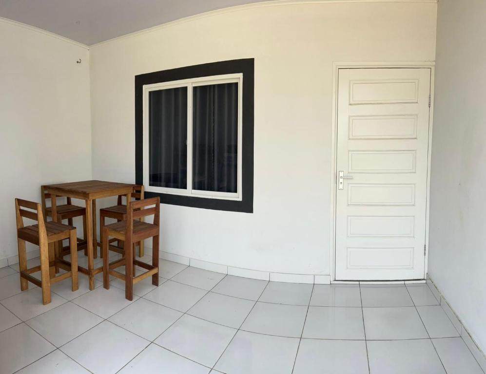 a room with a table and chairs and a window at SICE- Apartment 1 in Meerzorg