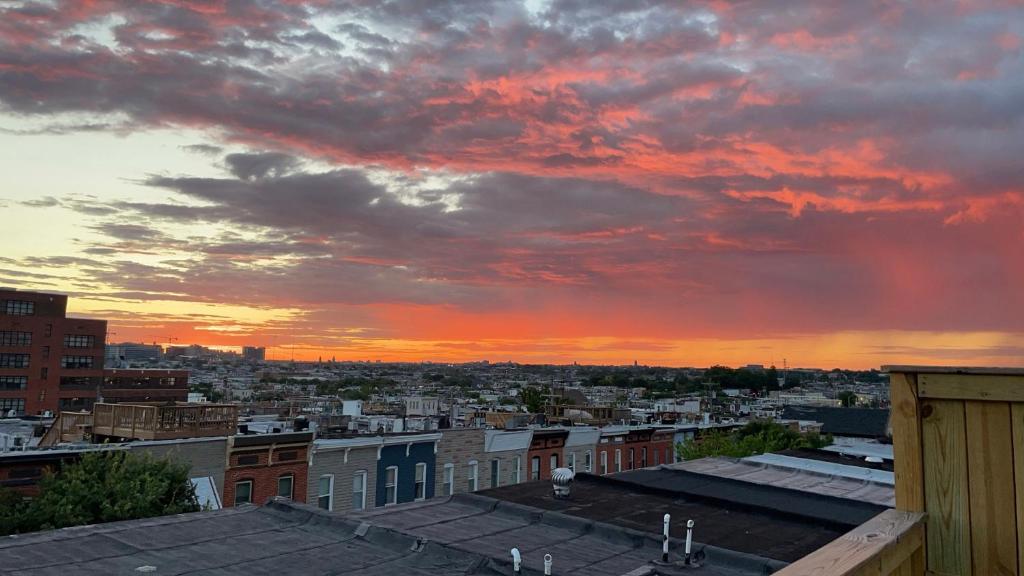 a view of a city skyline with a sunset at The Blue House! Modern+ Rooftop deck+ Parking in Baltimore