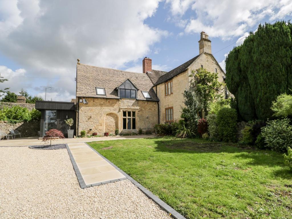 an exterior view of a house with a yard at Suncroft in Cheltenham