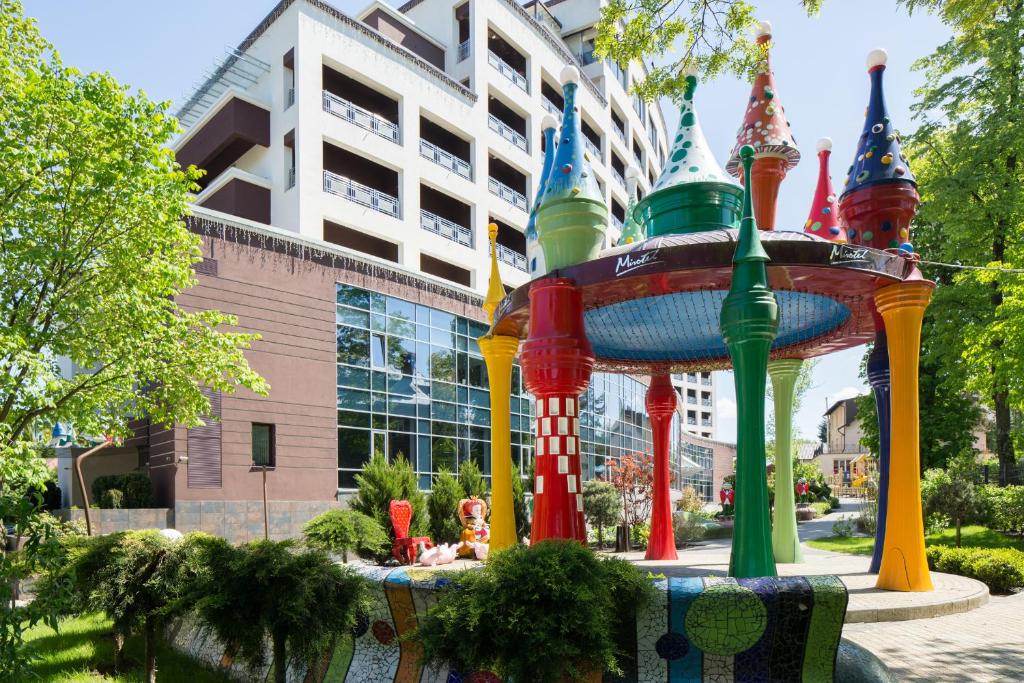 a colorful fountain in front of a building at Mirotel Resort and Spa in Truskavets