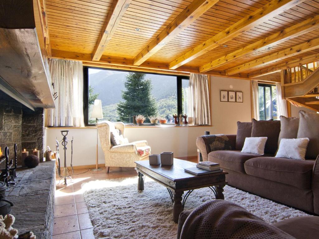 a living room with a couch and a table at Modern Mansion in Vielha with Sauna and bubble bath in Vielha