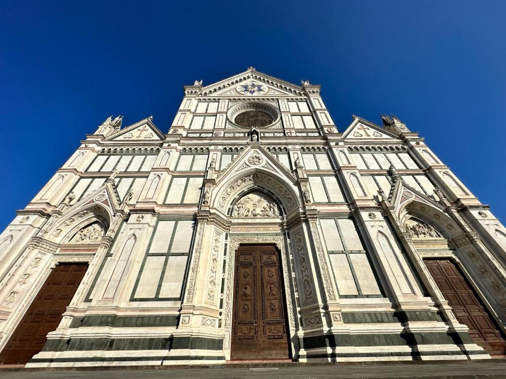 a tall tower of a building with a blue sky at Luxurious View on Santa Croce in Florence