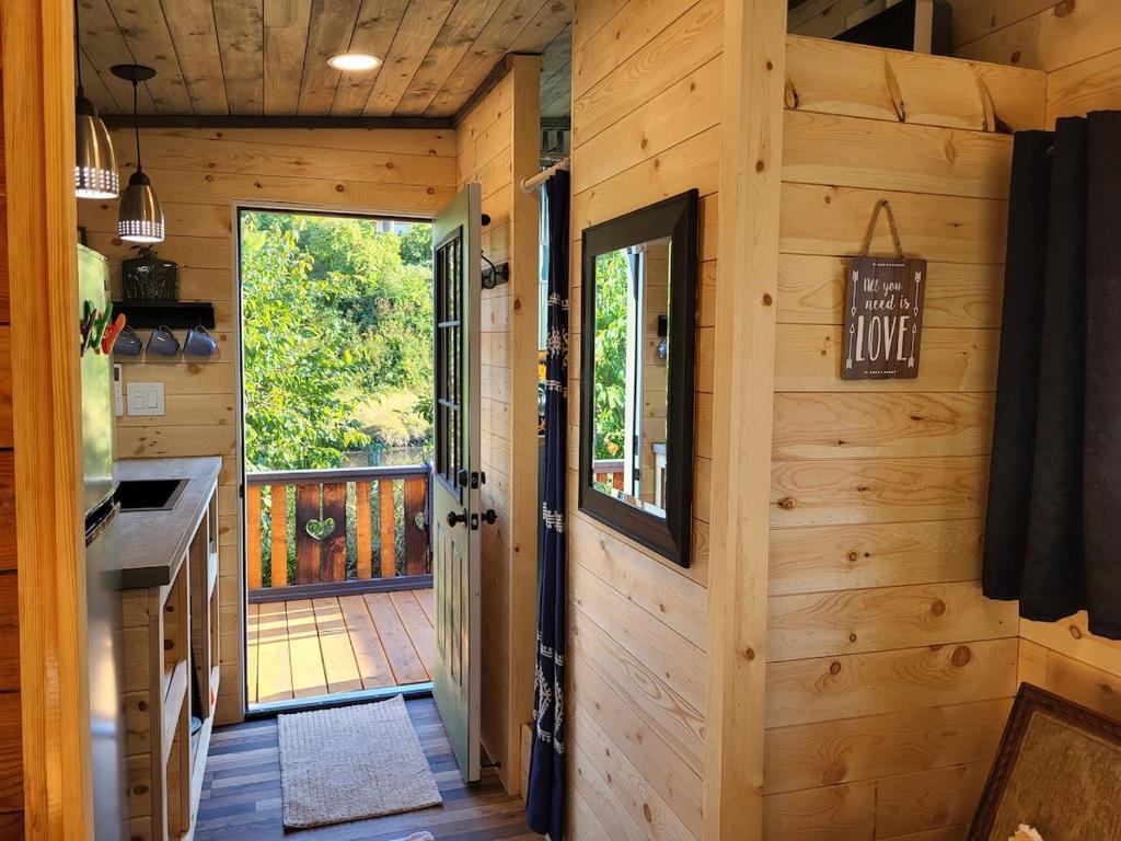 a kitchen with a door leading to a deck at Tiny Home By The Beach in Blaine