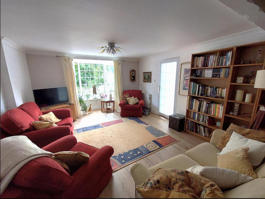 a living room with two couches and a tv at Carbis Bay luxury ground floor flat close to beach in Carbis Bay