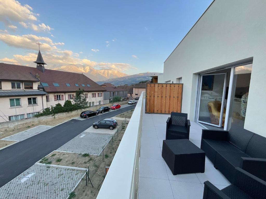 a balcony of a house with a view of a street at Appartement au pied du Mont-Blanc 2! in Sallanches
