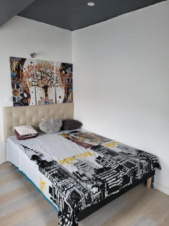 Dormitorio con cama con dosel en la pared en Hamidani jkkld, en Aureilhan
