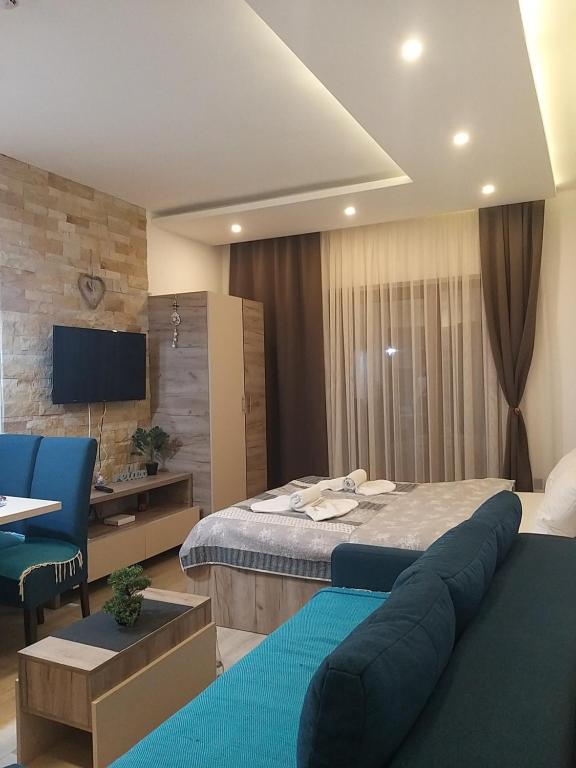 a hotel room with a large bed and a desk at Ogy's apartment in Kopaonik