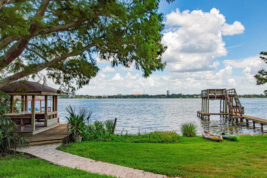 a lake with a dock and a gazebo at Lake Howard Hideway in Winter Haven