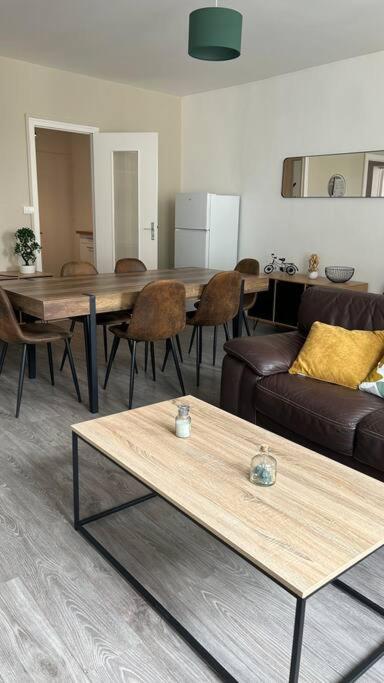 a living room with a couch and a table at Appartement cœur de ville in Châtillon-sur-Indre