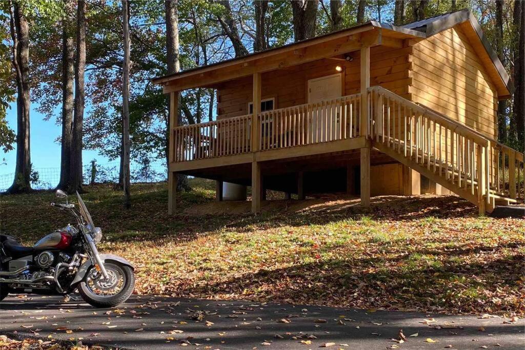 a motorcycle parked in front of a log cabin at Foxtail Orchards - The Iron Horse in Tazewell