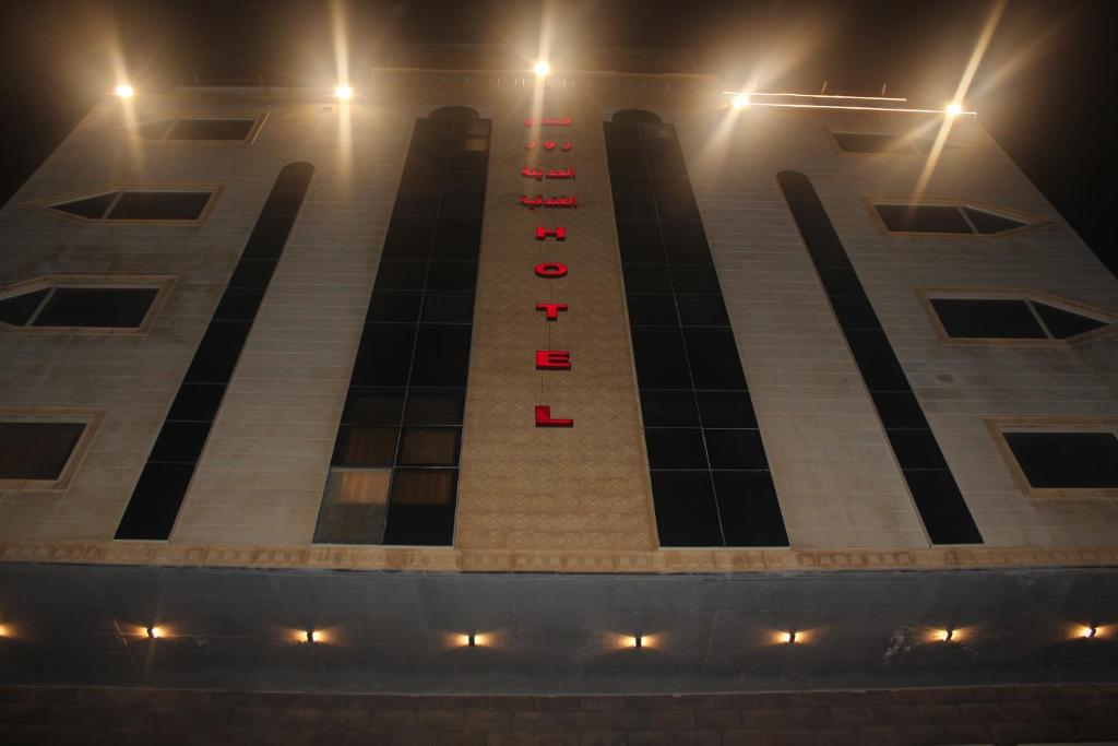 a large building with red lights on it at night at Rose Al Haditha Hotel in Jeddah