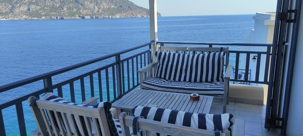 two chairs sitting on a balcony overlooking the ocean at Sea view in Karpathos Town