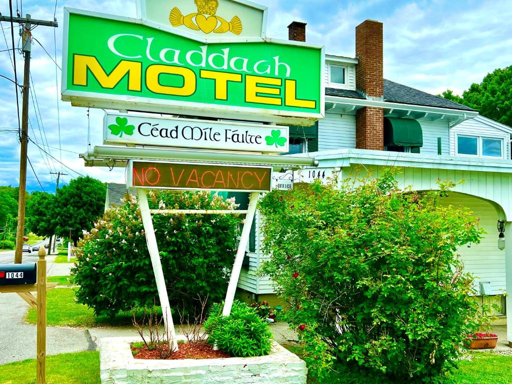 a motel sign in front of a house at Claddagh Motel & Suites in Rockport
