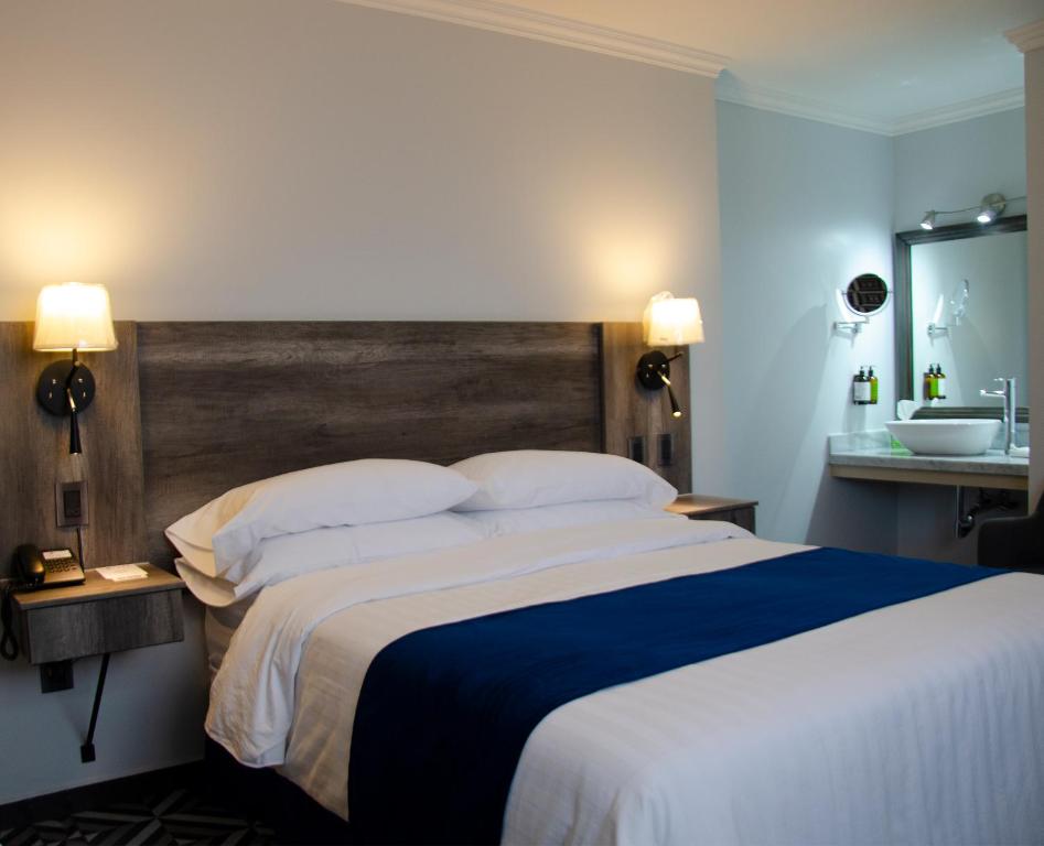 Postel nebo postele na pokoji v ubytování Hotel Esfera Tulancingo