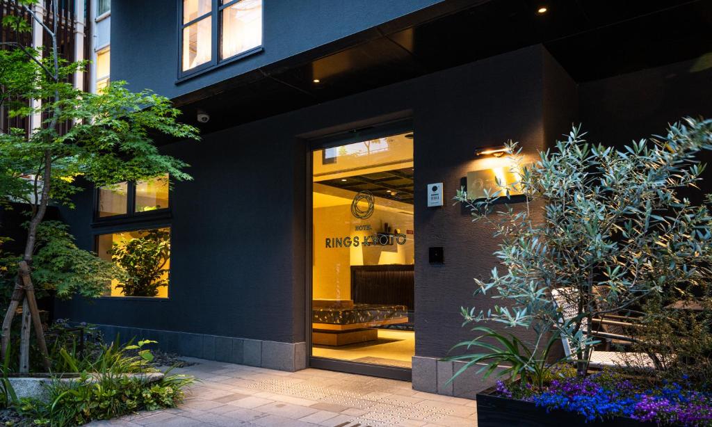 a front door of a building with plants at HOTEL RINGS KYOTO in Kyoto