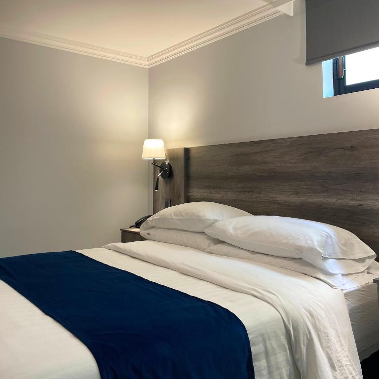 Postel nebo postele na pokoji v ubytování Hotel Esfera Tulancingo
