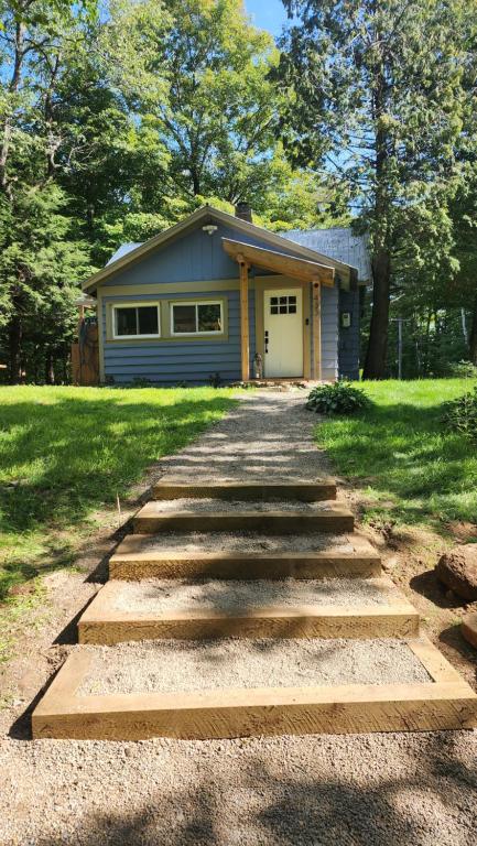 a stone path leading to a house with a garage at Rustica Retreats Cottage in Middle Grove